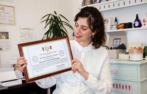 Pascale holding Certified Skincare Coach certificate