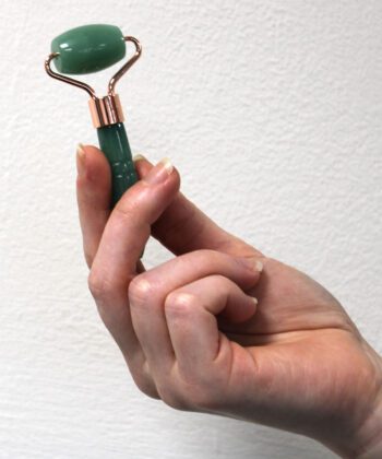 mini jade face roller in hand