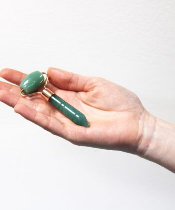 mini jade face roller in palm